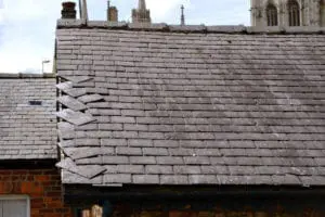 Loose slates on a house roof Loose slates on a house roof