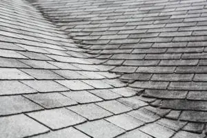 Old composite roof with damage Old composite roof with damage